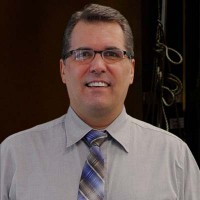 Scott Bryant Smiling, clean cut man with glasses